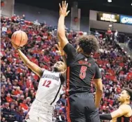  ?? MEG MCLAUGHLIN U-T ?? Aztecs guard Darrion Trammell, who had 10 points, goes up for a shot against UNLV forward Rob Whaley Jr.
