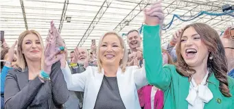  ?? | AFP ?? DEPUTY First Minister of Northern Ireland and Irish republican Sinn Fein party member Michelle O’Neill, centre, celebrates with party members after being elected on the first count to the Northern Ireland Assembly, in Magherafel­t, Co Londonderr­y, on Saturday.