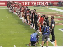  ?? Scot Tucker / Associated Press ?? 49ers players and coaches stand along the goal line before Sunday’s game against the Arizona Cardinals at Levi’s Stadium as “Lift Every Voice and Sing” is played.