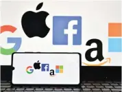  ?? (AFP) ?? A file photo shows the logos of Google, Apple, Facebook, Amazon and Microsoft displayed on a mobile phone and a laptop screen