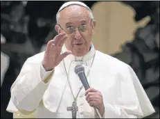  ??  ?? Pope Francis speaks during a meeting with the media Saturday at the Pope VI hall, at the Vatican. Pope Francis offered intimate insights Saturday into the moments after his papal election.