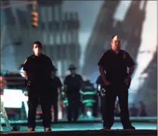  ?? Associated Press file photo ?? Police officers stand guard near the site of the World Trade Center in New York, in this Sept. 12, 2001, file photo.