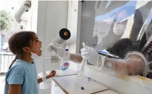  ?? (Marc Israel Sellem/The Jerusalem Post) ?? A CHILD is swabbed for a coronaviru­s test at a Meuhedet testing center in Jerusalem yesterday.