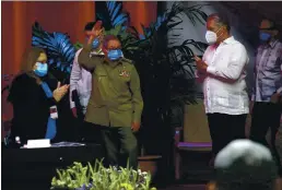  ?? ARIEL LEY ROYERO — ACN VIA AP ?? Raul Castro, first secretary of the Communist Party, waves to members at Cuba’s opening session of Congress on Friday as Cuban President Miguel Diaz-Canel, right, applauds.