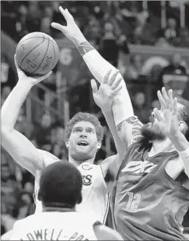  ?? Photograph­s by Sue Ogrocki Associated Press ?? LAKERS CENTER Brook Lopez shoots in front of Oklahoma City center Steven Adams in the first half of the Lakers’ 108-104 victory. Lopez scored 20 points.