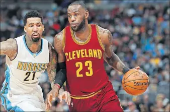  ?? ZALUBOWSKI/THE ASSOCIATED PRESS] [DAVID ?? Cleveland Cavaliers forward LeBron James, right, drives the lane past Denver Nuggets forward Wilson Chandler in the first half Wednesday in Denver. The Cavs lost 126-113.