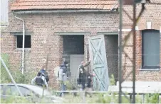  ?? — AFP photo ?? Gendarmes enter during a search of the house in Bullecourt, northern France.