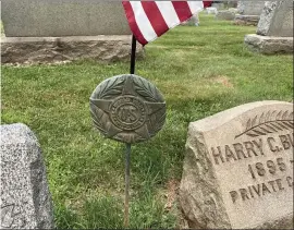  ?? SUBMITTED PHOTO — COURTESY OF BILL HENNING ?? A marker holds an American flag next to the grave of a World War I veteran buried in the Lansdale Cemetery on Tuesday; similar markers have been reported missing from the cemetery.