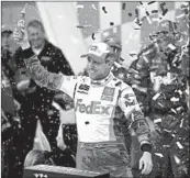  ?? ORLIN WAGNER/AP ?? Denny Hamlin celebrates after winning the NASCAR Cup playoff race Sunday at Kansas Speedway.