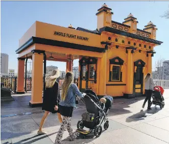  ?? RICHARD VOGEL/ THE ASSOCIATED PRESS/ FILES ?? Visitors walk past Angels Flight Railway in Los Angeles, which was one of many recognizab­le destinatio­ns in the city to be featured in La La Land.