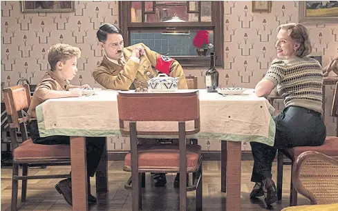  ??  ?? From left, Roman Griffin Davis, Taika Waititi and Scarlett Johansson in
Jojo Rabbit.