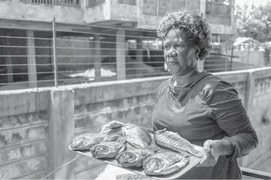  ?? ?? Caroline Onyango delivers fish to a client Sept. 22 in Ngong, Kenya. She has worked in tourism for more than 15 years.