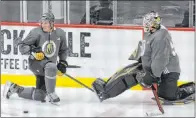  ??  ?? Knights defenseman Nate Schmidt talks with backup goaltender Robin Lehner during practice Monday at City National Arena.