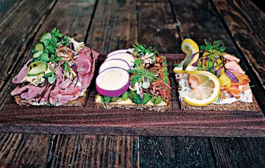  ?? KATY CARROLL PHOTO ?? Roast beef, asparagus and juniper-smoked salmon are among the types of open-faced sandwiches served at Freya Cafe in Seattle.