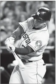  ?? AP/PATRICK SEMANSKY ?? Houston Astros’ Michael Brantley hits a RBI-single against the Washington Nationals during the third inning of Game 3 of the World Series on Friday in Washington.