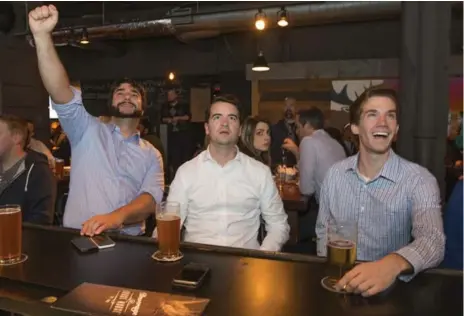  ?? RICK MADONIK/TORONTO STAR ?? From left, Dimitri Mazur, Patrick Schofield and Jamie Cruickshan­k take in the first Jays-Orioles game at The Loose Moose on Front St. on Wednesday.