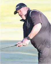  ??  ?? Paul Kaye watches his ball as it approaches the fifth green out of the light rough.