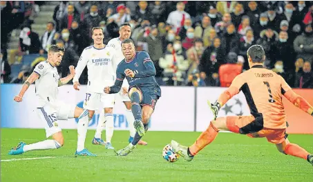  ?? ?? Paris Saint-Germain's Kylian Mbappe (C) scores during the UEFA Champions League round of 16 first leg match against Real Madrid on Tuesday.