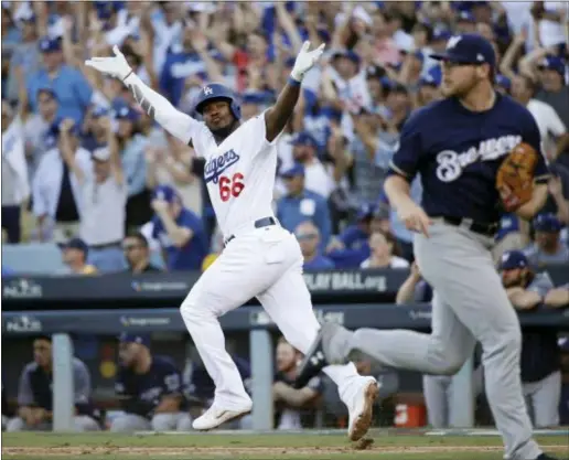  ?? JAE HONG — THE ASSOCIATED PRESS ?? The Dodgers’ Yasiel Puig reacts after hitting an RBI single during the sixth inning of Game 5 of the National League Championsh­ip Series against the Brewers Wednesday in Los Angeles.