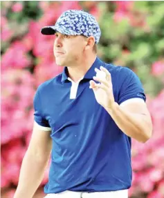  ?? — AFP photo ?? American Brooks Koepka acknowledg­es fans after making a birdie at 13 in the first round of the Masters at Augusta National.