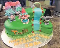  ?? SUBMITTED PHOTO ?? This trolls cake was the first order the girls received that wasn’t for a friend or family member. It took six hours to sculpt the four troll characters.