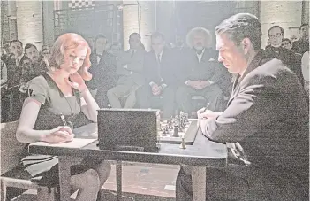  ?? Netflix photo — ?? Anna Taylor-Joy as the fictional Beth Harmon in ‘The Queen’s Gambit,’ with Marcin Dorocinski as Vasily Borgov.