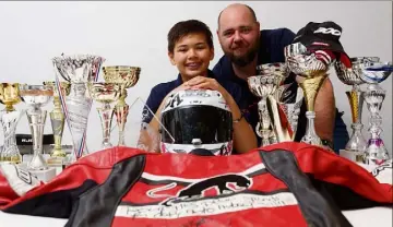  ?? (Photo Dominique Leriche) ?? Alexis et son père, Arnaud, au milieu des trophées glanés en catégories jeunes.