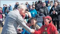  ?? CP PHOTO ?? Prince Charles shakes hands with locals as he participat­es in an event, Thursday in Iqaluit, Nunavut.