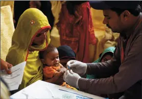  ?? GETTY IMAGES BY RIZWAN TABASSUM/AFP ?? A Pakistani paramedic takes a blood sample from a baby for a HIV test at a state-run hospital in Rato Dero in the district of Larkana of the southern Sindh province on May 9.