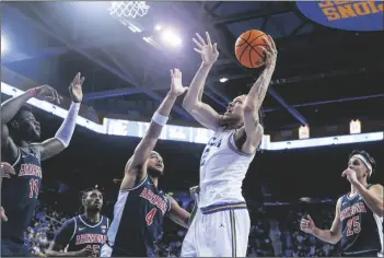  ?? RINGO H.W. CHIU VIA AP ?? UCLA
FORWARD MAC ETIENNE shoots against Arizona guard Kylan Boswell (4) during the second half of a game on Saturday in Los Angeles.