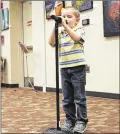  ??  ?? Isaac, 4, sings the Alphabet Song, backward, at the show. Nearly 100 people attended.