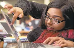  ??  ?? Overfelt High School student Jocelyn Carrillo, 16, uses a Chromebook to design a T-shirt at the school library on Saturday.