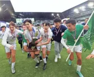  ?? ?? Grandview Heights boys soccer players take the Division III state championsh­ip trophy.