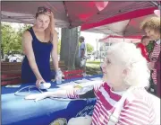  ?? AP/The Citizens’ Voice/MARK MORAN ?? Kady Luchetti, a registered nurse with the Health Department in Wilkes-Barre, Pa., checks Margaret Kopko’s blood pressure during the department’s “Mondays at the Market” in the city’s downtown public square.