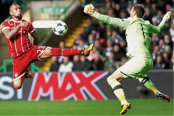  ?? — Reuters ?? Chilling Chilean: Bayern Munich’s Arturo Vidal trying to score past Celtic goalkeeper Craig Gordon in the Champions League match in Glasgow on
Tuesday. Bayern won 2-1.