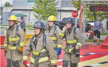  ?? [SUBMITTED] ?? Madison Lavigne from Linwood, along with other Wellesley Township firefighte­rs Clayton Greer, Dave Uberig and Ryan Dosman, placed third at the national Firefit competitio­n in Calgary earlier this month.