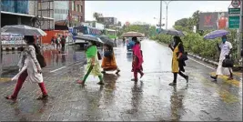  ?? PIC/PTI ?? People walk during rain as monsoon hits Kerala to embark the season in the country amid Coronaviru­s pandemic