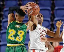  ?? Michael Wyke ?? Cypress Falls’ Nigel Hawkins (23) tries to make a pass, but Bellaire’s Doug Young has other ideas Tuesday night.