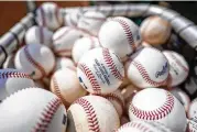  ?? BRYAN WOOLSTON / AP ?? Major League Baseball is standardiz­ing procedures for rubbing baseballs and their removal from humidors in an effort to establish more consistenc­y.