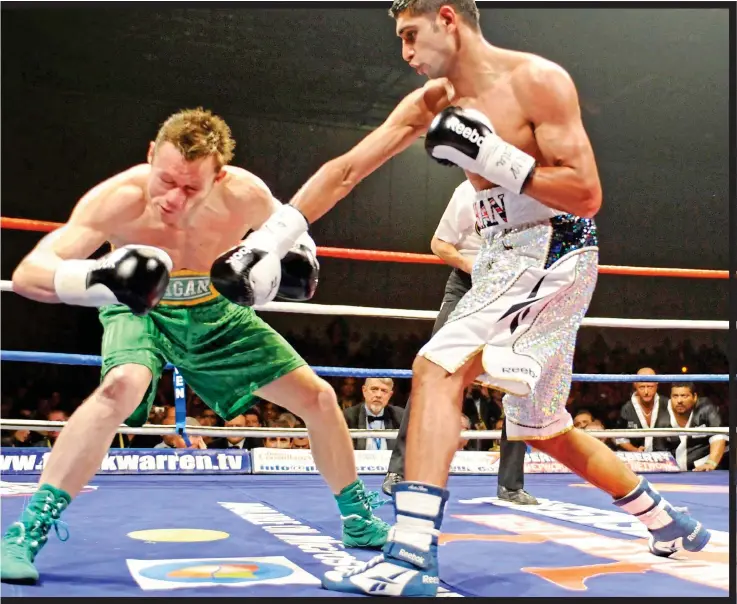  ??  ?? LOW POINT: Defeat by Amir Khan in 2008 (main) was tough for Oisín Fagan who now coaches kids along with fellow ex-boxer Michael Carruth (right)