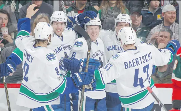  ?? GETTY IMAGES ?? Brock Boeser was the centre of attention after scoring his first NHL goal against Minnesota on March 25. Boeser scored four goals in nine NHL games to end the season.