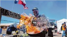  ?? Raquel Natalicchi­o/Staff photograph­er ?? Chef Ruben Quiroz prepares a dish at the rodeo’s World’s Championsh­ip Bar-B-Que competitio­n on Feb. 23.