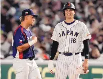  ?? EUGENE HOSHIKO/ASSOCIATED PRESS ?? Shohei Ohtani, right, of Japan and Martin Muzik of the Czech Republic meet at first base Saturday during their Pool B game at the World Baseball Classic at the Tokyo Dome in Japan.