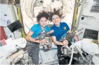  ?? NASA VIA THE ASSOCIATED PRESS ?? U.S. astronauts Jessica Meir, left, and Christina Koch’s main job was to replace the faulty 19-year-old charge-regulating device.