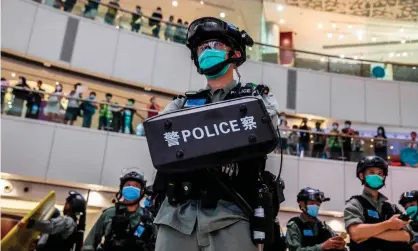  ??  ?? A riot police officer stands guard during a clearance operation at a demonstrat­ion in a mall in Hong Kong Photograph: Isaac Lawrence/ AFP/Getty