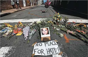  ?? CHIP SOMODEVILL­A/GETTY ?? A makeshift memorial to Heather Heyer, 32, appears Sunday on a street in downtown Charlottes­ville, Va.