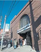  ?? RICK MADONIK TORONTO STAR FILE PHOTO ?? People line up outside the COVID-19 assessment centre at Toronto Western Hospital. The pandemic has added to struggles at city shelters.