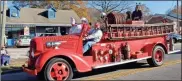  ?? Olivia Morley, File ?? In this 2020 photo, Santa Claus waves from a vintage fire engine. The Lindale Christmas Parade will take place on Saturday. In the evening, the annual lighting of the Star Between The Stacks of the old mill will take place.