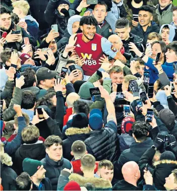  ??  ?? Wembley bound: Tyrone Mings and Aston Villa fans celebrate beating Leicester in the Carabao Cup semi-final