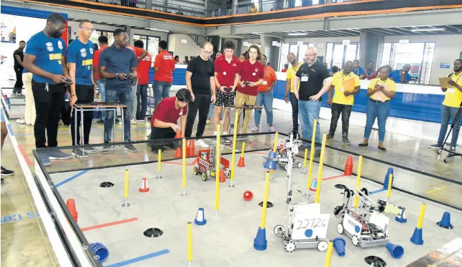  ?? FILE ?? In this February photo, students from Munro College and Carol Morgan High School, Dominican Republic, compete in a robotics competitio­n at Jamaica College.